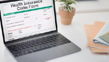 An insurance claim form on a laptop