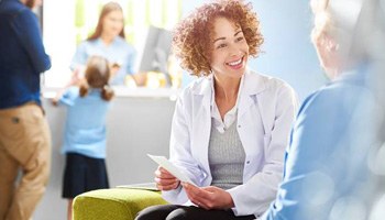 Dental team member smiling at patient