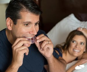 Man placing his sleep apnea appliance