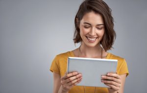 Smiing woman looking at tablet