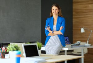 Business woman standing near her workplace.