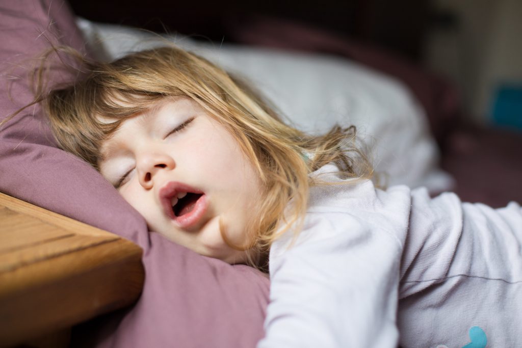 Young girl sleeping with mouth oopne