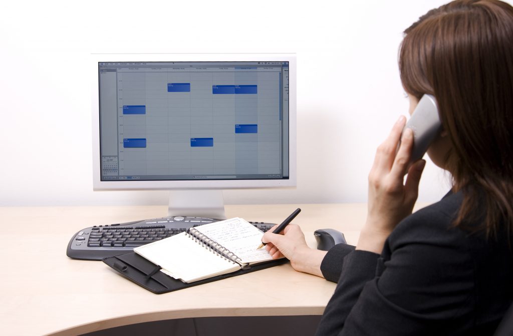 Woman on phone looking at calendar