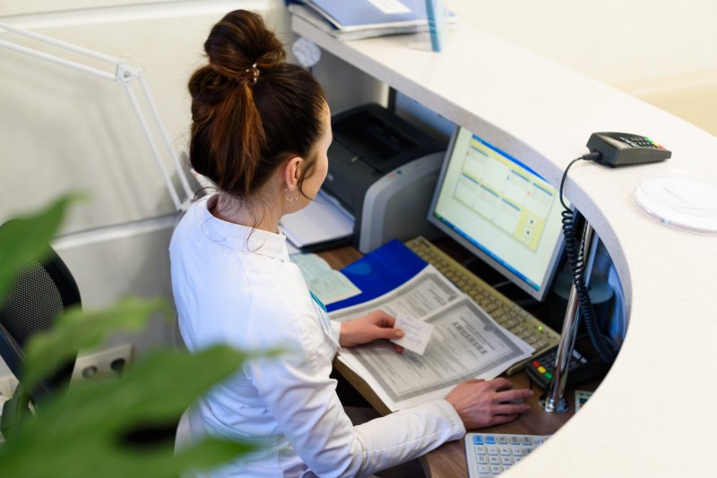 A woman sitting behind a computer desk