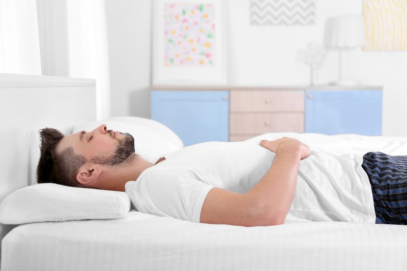 A man asleep on his bed