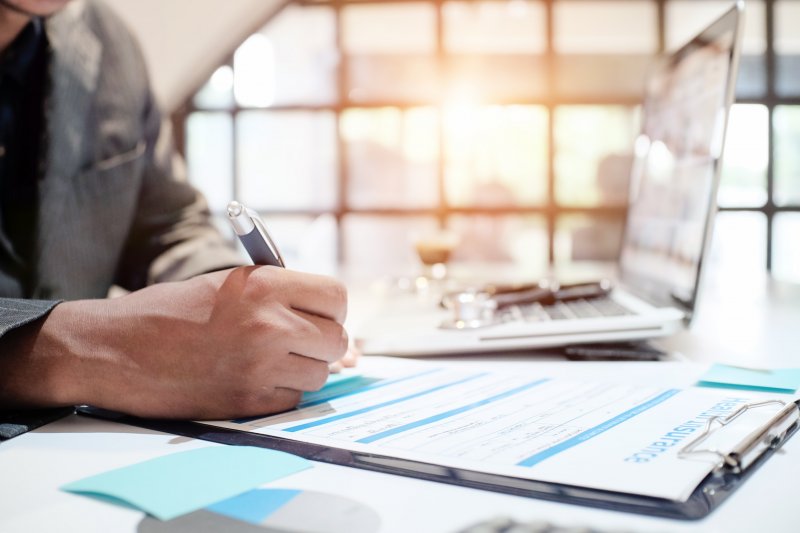 A doctor filling out the necessary paperwork to become an in-network provider