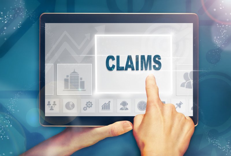 A digital image of a person using a tablet and the word “Claims” appearing on the screen